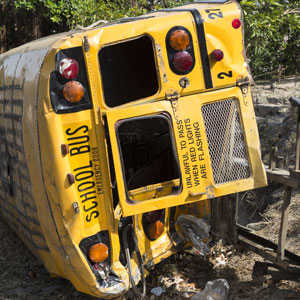 A wrecked school bus, highlighting the bus accident - Pigott Law Group