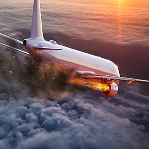 Commercial airplane engine fire over clouds; legal help for airline accidents in Buffalo, NY.