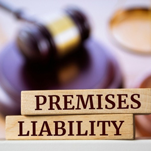 Premises Liability wooden blocks with a gavel; legal help for slip and fall injuries on properties.